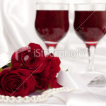 stock-photo-15184192-roses-with-pearls-and-glasses-of-wine-on-white-satin